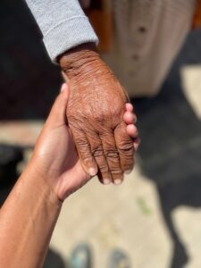 a close up of two people holding hands
